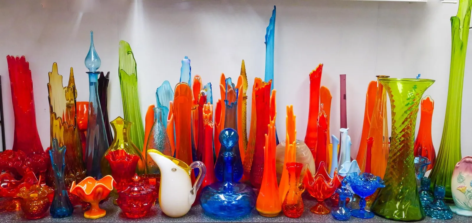A long row of colorful vintage art glass