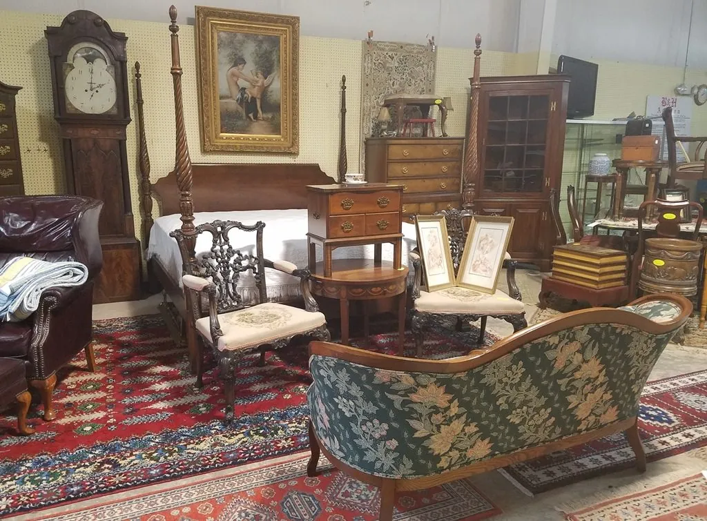 A B&H gallery preview with tall clocks, a four-poster bed, chests and rugs