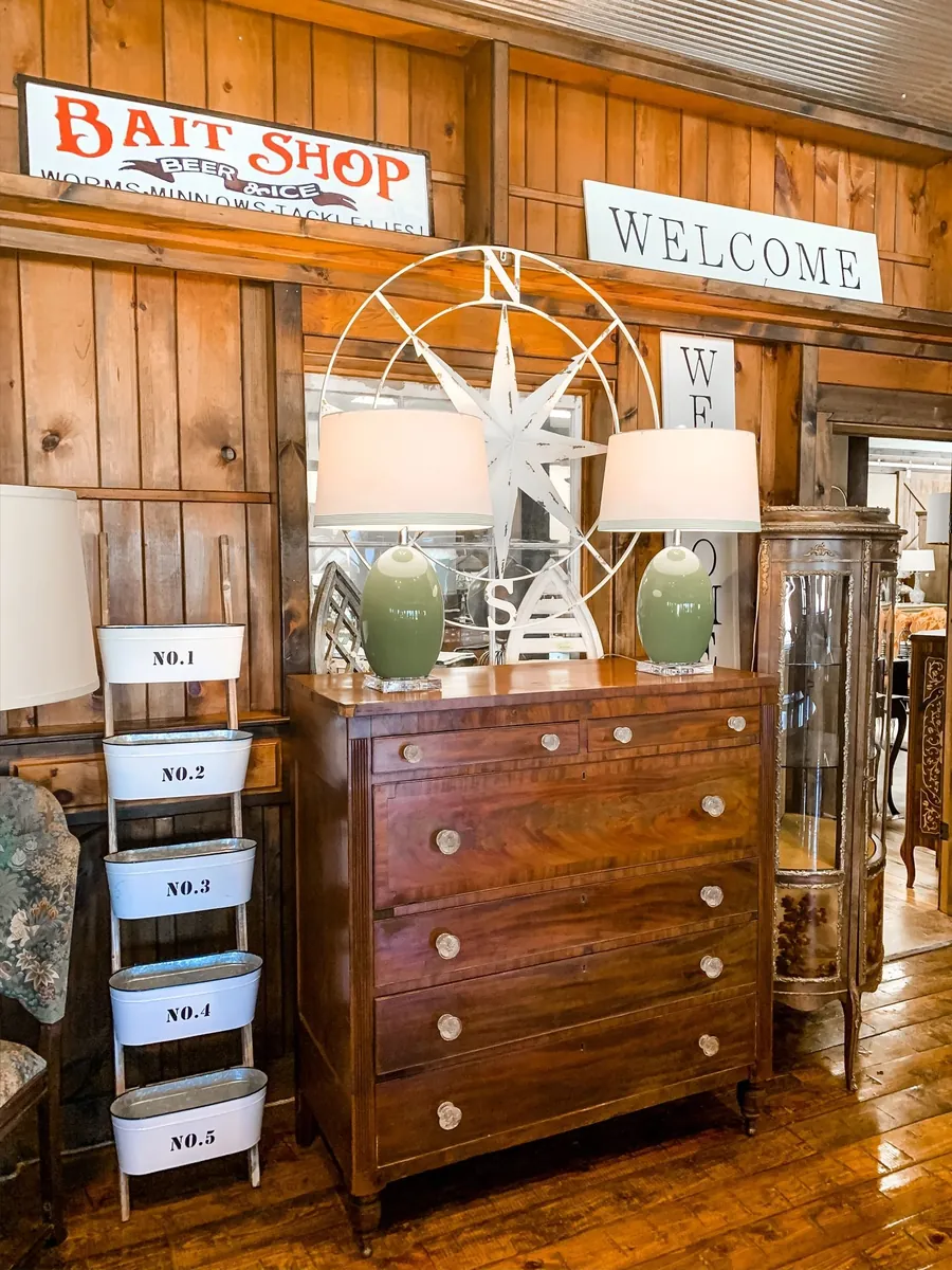 A room in the Market with a mahogany chest and green lamps
